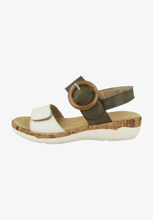 Velcro sandal with white leather upper, olive green strap, wooden cork midsole, and round wooden accent. Lightweight foam outsole.