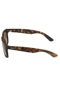 Ochelari de soare tortoise brown cu un design geometric, rame groase din acetat și lentile translucide. Logo pe braț.