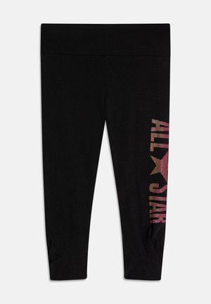 Μαύρες κολάν με πολύχρωμο γραφικό "ALL STAR" με κουκίδες κατά μήκος του αριστερού ποδιού. Το υλικό είναι λείο, με εφαρμοστό σχέδιο και λεπτομέρεια στον αστράγαλο.