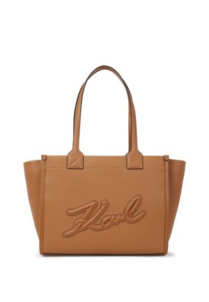 Tan textured leather tote bag with double handles and an embossed script logo "Karl" on the front.