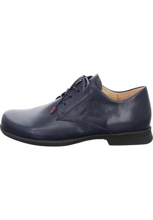 Navy blue leather dress shoe with a smooth texture, low profile, and tonal laces. Features a subtle red accent near the eyelet.