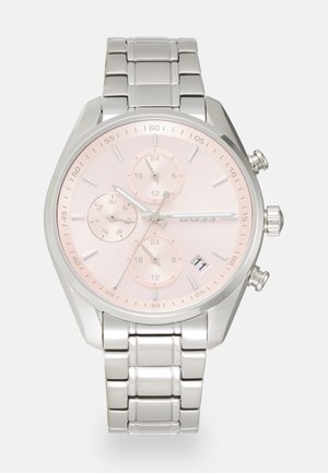 Montre en acier inoxydable avec un cadran rose, des chiffres arabes, trois sous-cadrans et un affichage de la date ; bracelet en métal poli avec une fermeture sécurisée.