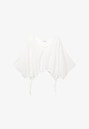 Haut court blanc en tissu texturé avec de larges manches courtes. Présente un décolleté en V et des liens latéraux ajustables pour un ajustement parfait.