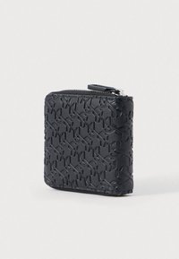 Black zippered wallet made of textured material featuring an embossed pattern. Compact square shape with silver hardware accents.