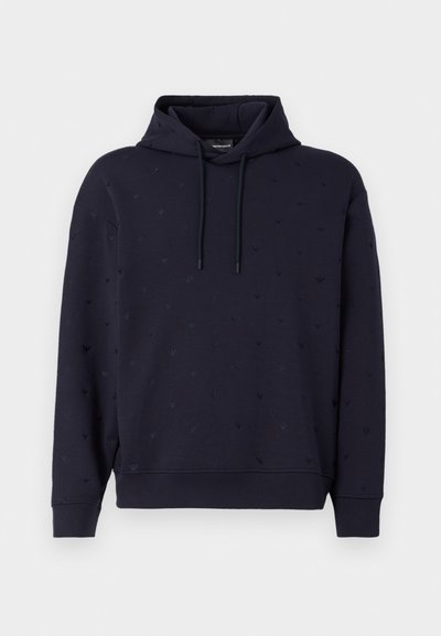Navy blue hoodie with a kangaroo pocket and adjustable drawstrings. Features subtle embossed patterns throughout. Soft, textured fabric.
