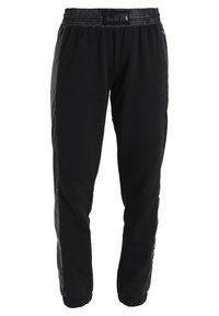 Black sweatpants with an elastic waistband, tapered leg design, and side panel accents. Made from a soft, stretchy fabric.