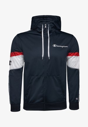 Sweat à capuche zippé bleu marine avec des bandes rouges et blanches sur les manches, cordons blancs, logo Champion sur la poitrine et les poignets, poches avant et capuche.