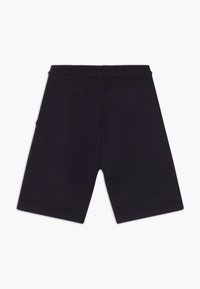Black cotton shorts with a stretchy waistband, featuring a smooth texture and an above-the-knee cut. No visible patterns or accents.