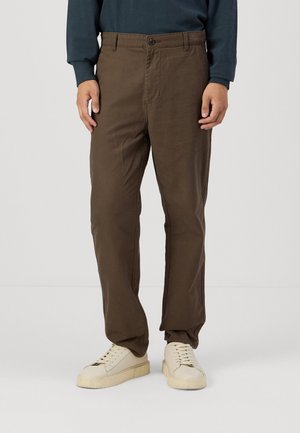Brown trousers made of soft cotton fabric, featuring a straight leg design, front button closure, and side pockets.