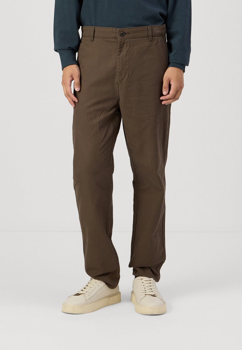Brown trousers made of soft cotton fabric, featuring a straight leg design, front button closure, and side pockets.