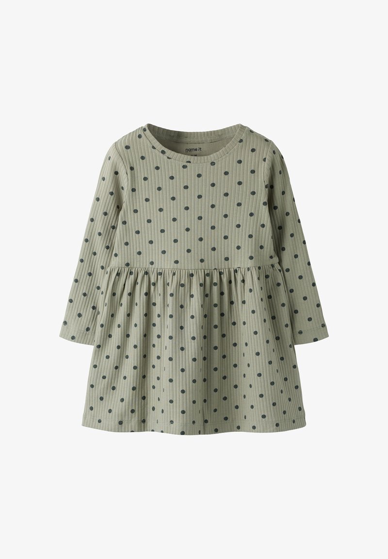 Φόρεμα με μακριά μανίκια σε ελιά πράσινο με κάθετη ριμπ υφή, διακοσμημένο με ναυτικό πουά και πιετά φούστα στη μέση.