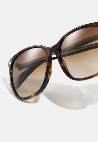 Tortoiseshell sunglasses with oversized square frames, gradient brown lenses, and subtle gold accents on the temples.
