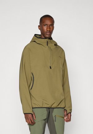 Olive green hooded jacket with a quarter zip, elastic hem, side pockets, and black accents. Soft, textured fabric with a relaxed fit.