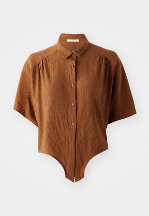 Brown short-sleeve button-up shirt with a textured fabric, curved hem, and a classic collar. Features four buttons with dark accents.