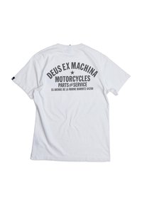 White cotton t-shirt with a relaxed fit features black text on the back: "DEUS EX MACHINA MOTORCYCLES PARTS and SERVICE" with a star.