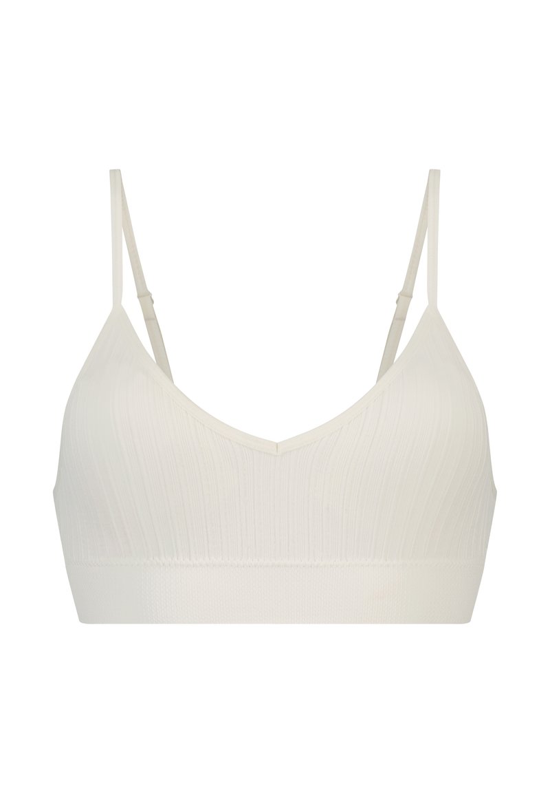 Lys beige bralette med V-hals, med ribbet tekstur og tynne justerbare stropper. Mykt stoff med en sømløs, elastisk design.