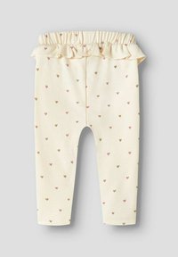 Crème-kleurige legging met een gerimpelde tailleband, voorzien van kleine roze en bruine hartpatronen door de stof heen. Zacht katoenmateriaal.