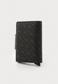 Black wallet made of textured synthetic material. Features a geometric pattern, slim design, and a noticeable side flap closure.