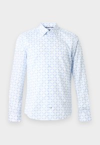 Chemise blanche à manches longues avec un motif géométrique bleu clair en forme d'étoile et un col classique sur un fond neutre.