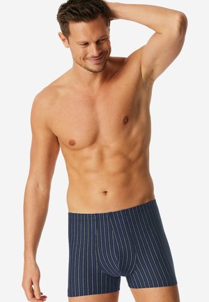 Boxers bleu foncé avec des rayures blanches et colorées, dotés d'un avant à poche et d'une texture douce.