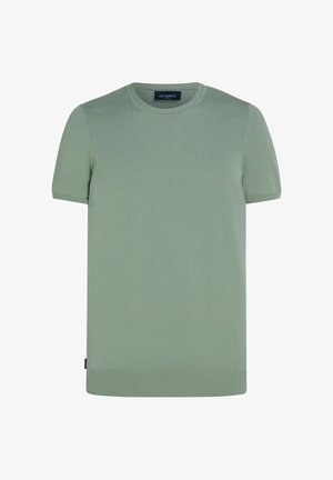 Chemise tricotée à manches courtes et col rond de couleur vert clair, avec col, poignets et ourlet côtelés, dotée d'une petite étiquette noire sur le côté.