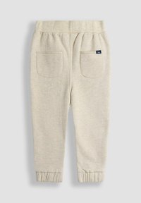 Hellbeige Jogginghosen aus weichem Material, mit einem gerafften Bund, Bündchen an den Beinen und zwei hinteren Taschen mit abgerundeten Kanten.