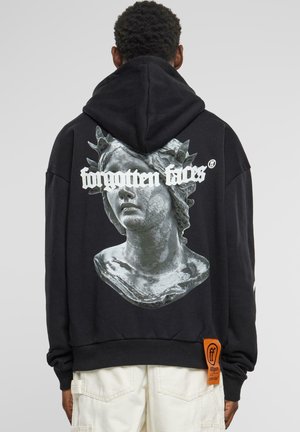 Black hoodie featuring a silver sculpture graphic on the back, with white text "forgotten faces" and an orange tag on the side.