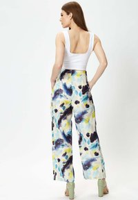 Wide-leg trousers featuring a multicolor abstract pattern with blue, yellow, and black hues; lightweight fabric, smooth texture.