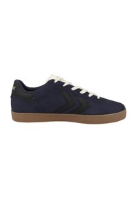 Navy suede sneakers with white laces, black accents, and a gum rubber sole. Features a chevron design on the side. Lightweight and low-profile.