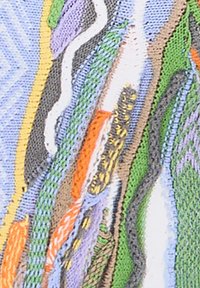 Colorful textile with abstract patterns. Features braided stitching in green, orange, and purple against a textured background of light blue and cream.