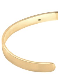 Gold-tone cuff bracelet with a smooth, polished surface and rounded edges. Marked with "925" indicating sterling silver content.