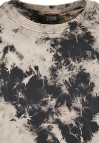 Tie-dye sweatshirt i beige og svarte nyanser. Mykt bomullsmateriale med rund hals og et unikt virvlende mønster. Størrelse M.