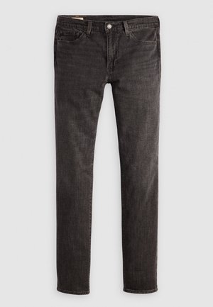 Jean en denim noir avec une coupe ajustée, présentant un design à cinq poches, un bouton en laiton et une texture subtile. Pas de motifs visibles ni d'ornements supplémentaires.