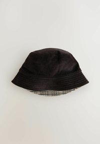 Black corduroy bucket hat with a textured surface and a checkered patterned trim at the base. Bucket shape with a wide, flexible brim.