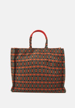Tote bag in patterned fabric featuring green, orange, and black hues. Two short red handles. Rectangular shape with structured sides.