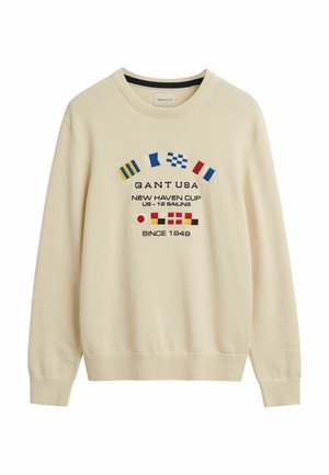Cream-colored sweatshirt made of soft fabric, featuring colorful nautical flags and embroidered text on the front. Ribbed cuff and hem details.