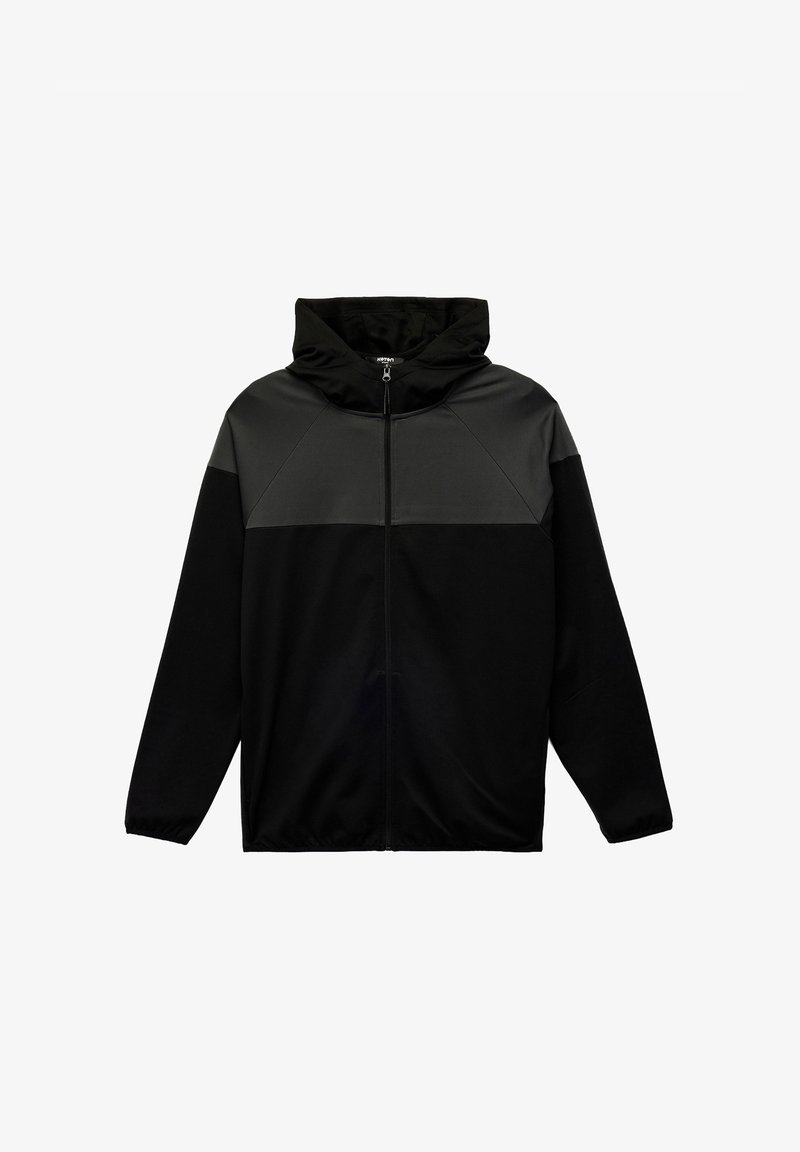 Zwarte zip-up hoodie met een grijze panel over de borst. Voorzien van een capuchon, lange mouwen en elastische manchetten. Zachte stoftextuur.