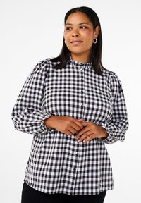 Button-up shirt in black and white gingham pattern; features a ruffled collar and puffed sleeves; made from lightweight fabric; relaxed fit.