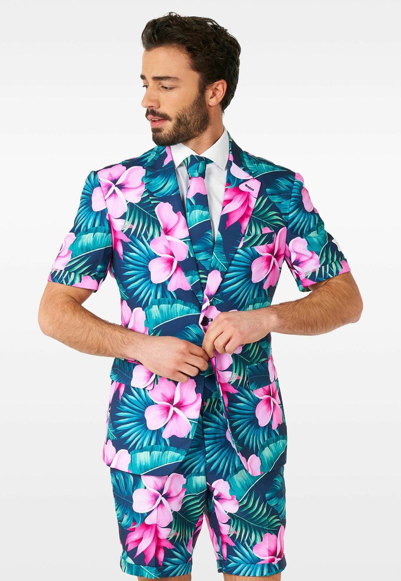 Kurzärmeliger Anzug mit einem lebhaften Blumenmuster, das pinke Blumen und grüne Blätter auf einem marineblauen Hintergrund zeigt, kombiniert mit einer passenden Krawatte.