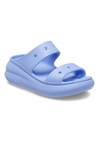 Zoccoli azzurri chiari realizzati in materiale morbido e flessibile, con due cinturini larghi e punta aperta. Presentano fori di ventilazione e una soletta texturizzata.