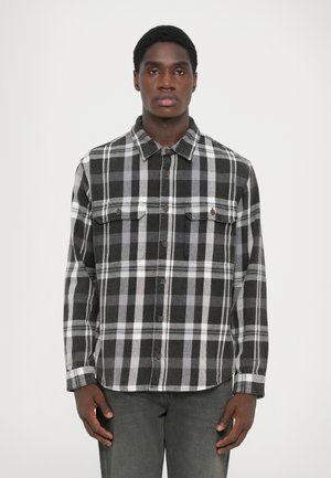 Zwart en grijs geblokt flanellen shirt met lange mouwen, een button-down kraag en twee borstzakken. Metalen knopen accenten sieren de voorkant.
