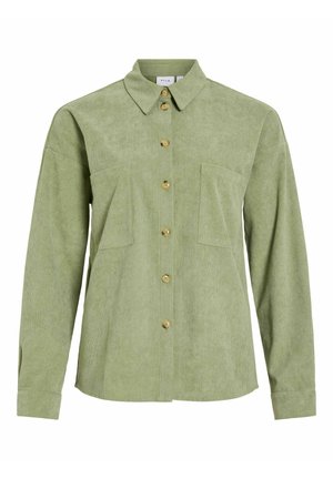 Chemise boutonnée en velours côtelé vert clair à manches longues, avec deux poches poitrine et un col classique.