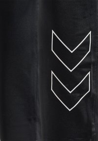 Black athletic pants with a smooth texture, featuring a white chevron pattern on the side. The design includes a slim fit and elastic waistband.
