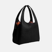 Zwarte leren totebag met brede dubbele handvatten en zichtbare bruine binnenvoering, tegen een effen lichte achtergrond.