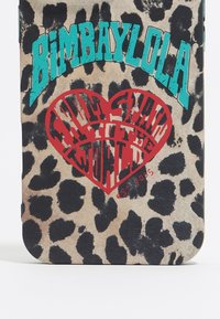 Funda de teléfono de estampado de leopardo con texto turquesa "Bimbaylola" y gráfico de corazón rojo que dice "Desde España para el mundo, est. 2005."