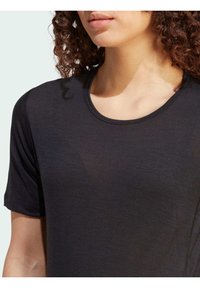Black short-sleeve shirt with a rounded neckline, made of soft fabric, featuring a smooth texture and simple, clean design.