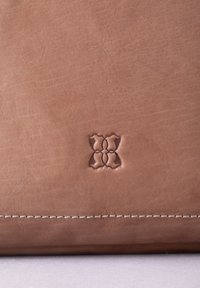 Brown leather bag featuring a subtle embossed logo, smooth texture, clean stitching, with a structured shape and minimalist design.