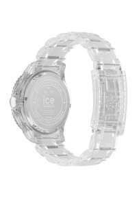 Orologio in plastica trasparente con cinturino trasparente, cassa rotonda e retro in acciaio inossidabile argentato. Presenta distintivi collegamenti a incastro.