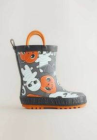Botte en caoutchouc grise avec des graphismes sur le thème d'Halloween représentant des momies et des citrouilles, des accents orange et une semelle noire texturée portant l'inscription "SPOOKY".
