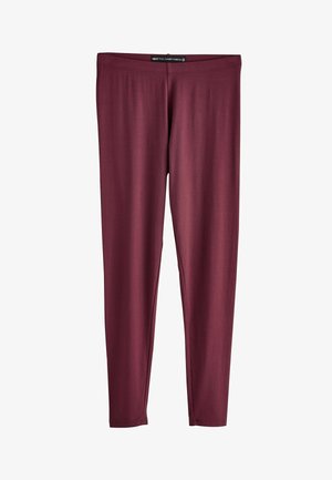 Helanke pune duljine u tamno crvenoj boji, s pripijenim strukom bez vidljivih uzoraka ili ukrasa.